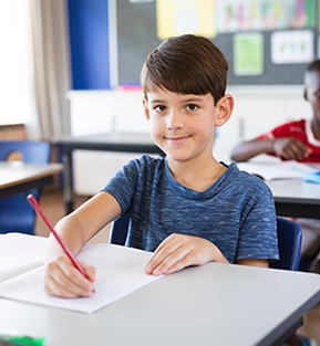 Elementary school boy sitting at his desk