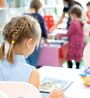 Young school girl engaged with learning in the classroom