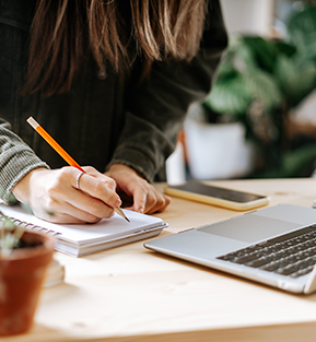 Young woman researching training opportunities on her laptop